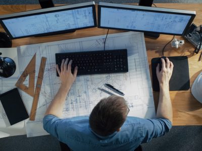 Top,View,Of,Architectural,Engineer,Working,On,His,Blueprints,,Holding Top,View,Of,Architectural,Engineer,Working,On,His,Blueprints,,Holding